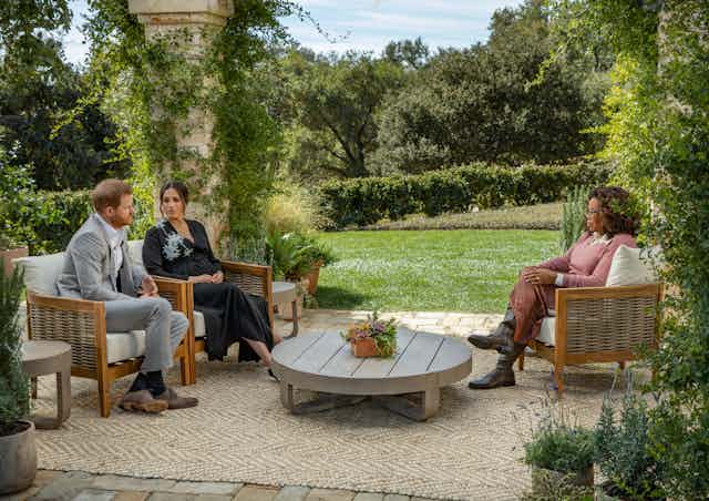Meghan Markle and Prince Harry are interviewed in a garden.