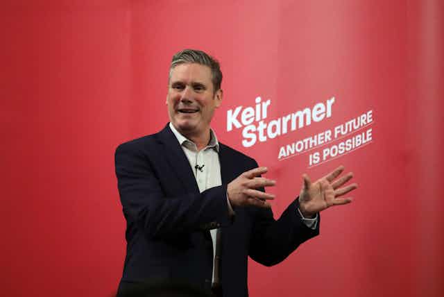 Keir Starmer speaking in front of a sign reading 'Another Future is Possible'.