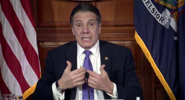 New York Governor Andrew Cuomo points to himself during a press conference.