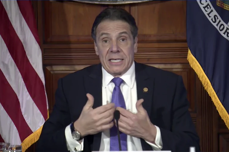 New York Governor Andrew Cuomo points to himself during a press conference.