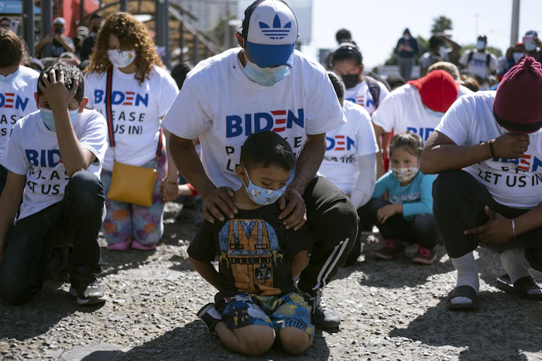 Migrants pray in Tijuana, Mexico.