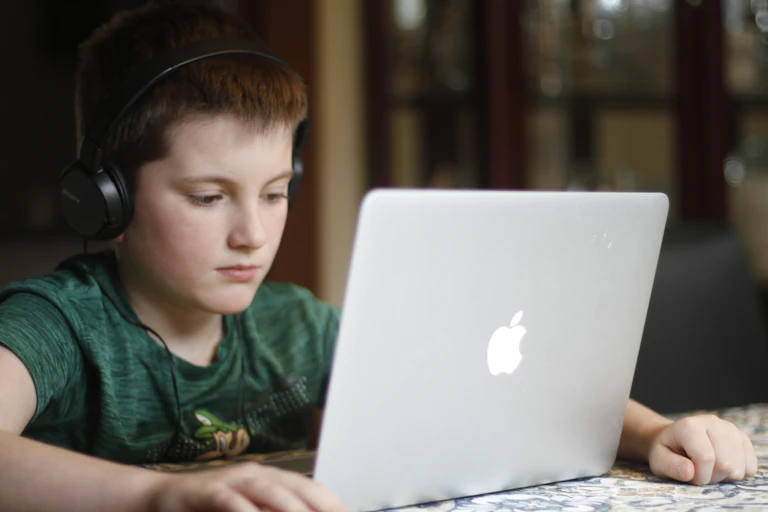 A boy on a laptop.