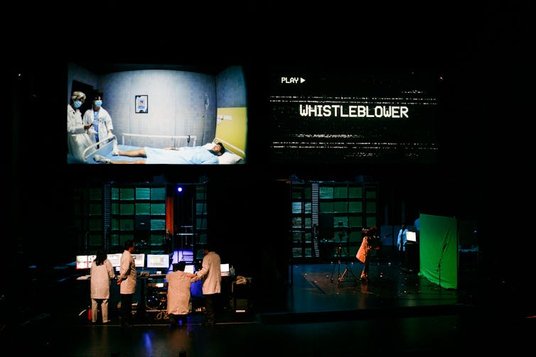 A full stage shot showing the technology and multiple screens.