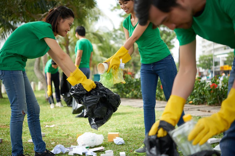 Young Asian people collect rubbish