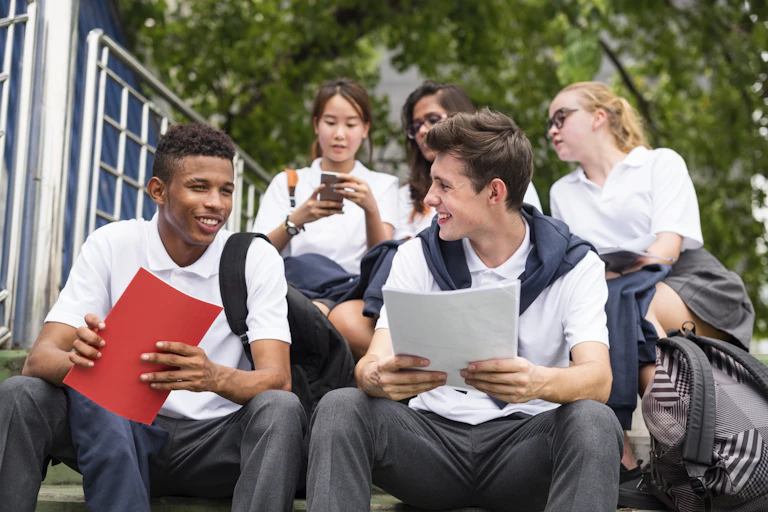 Group of students sitting on the steps chatting.