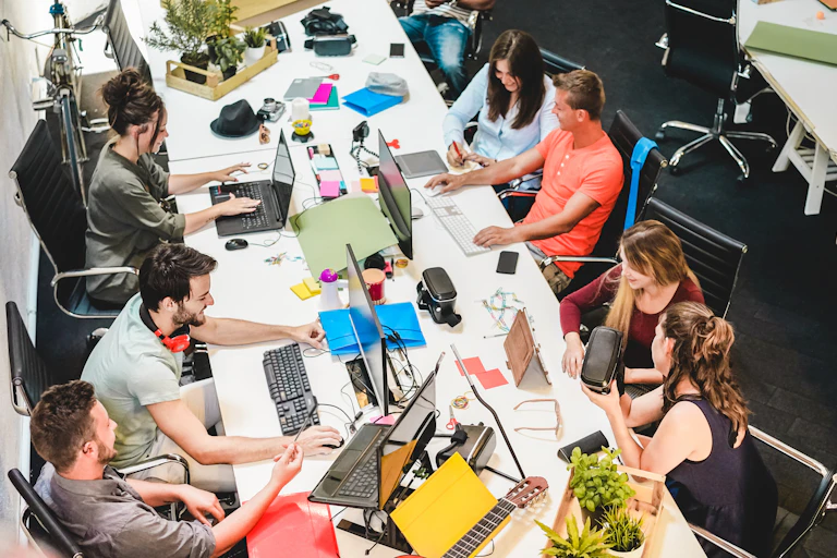 Adults at work all use their devices.