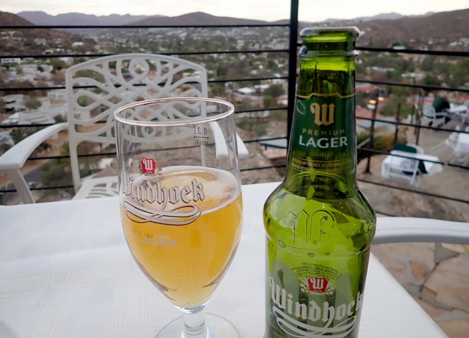 A bottle of Windhoek beer and a half-filled glass next to it