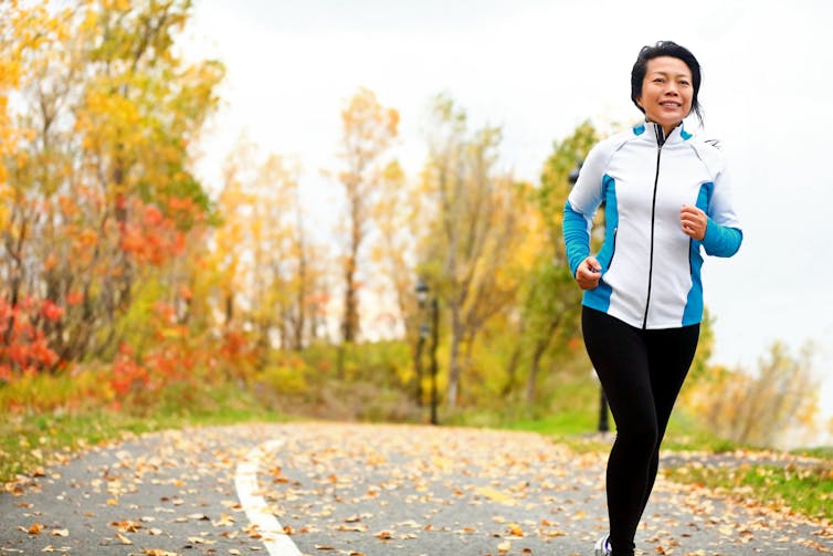 Woman running outdoors in the autumn.