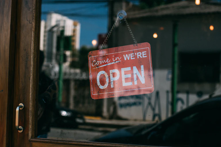Wiindow signs saying business is open