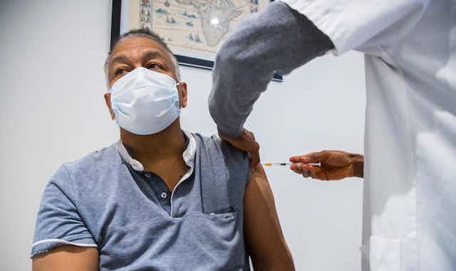 A man receiving dose of the AstraZeneca vaccine in Paris