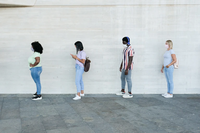 Six people wait in a queue
