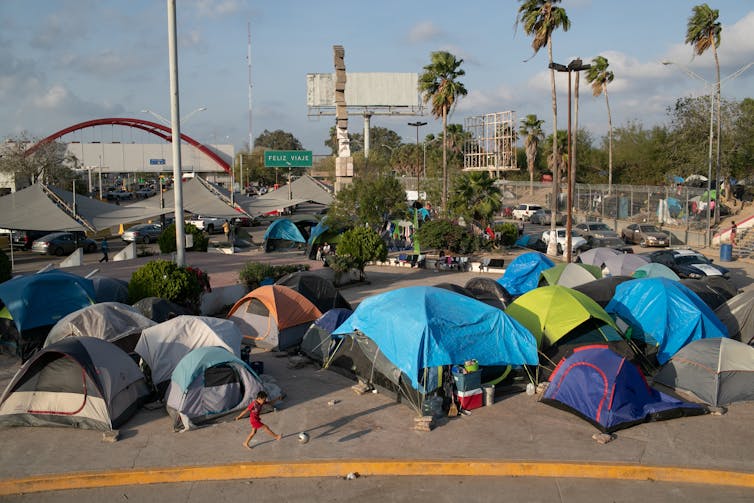 Dozens of tents in a parking lot