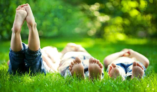 People relaxing on grass in a park