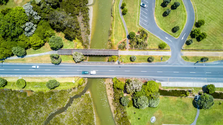 Road running through green spaces.