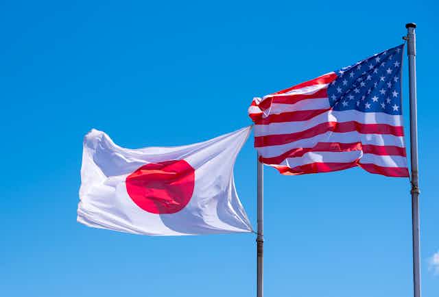 Japanese and US flags flying side-by-side.