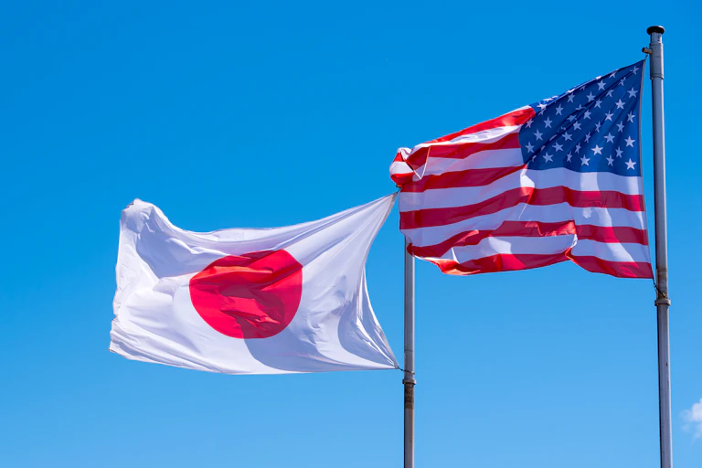 Japanese and US flags flying side-by-side.