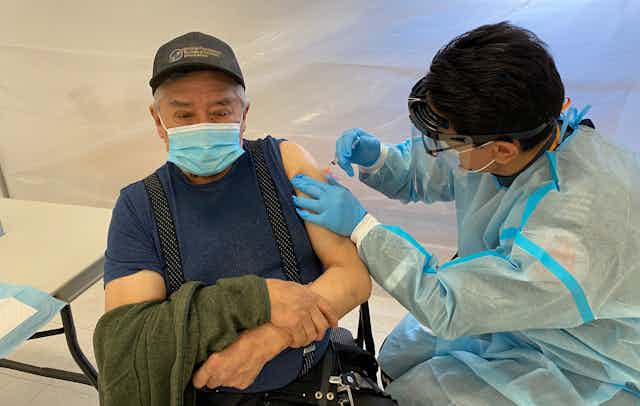 Indigenous man receives vaccine