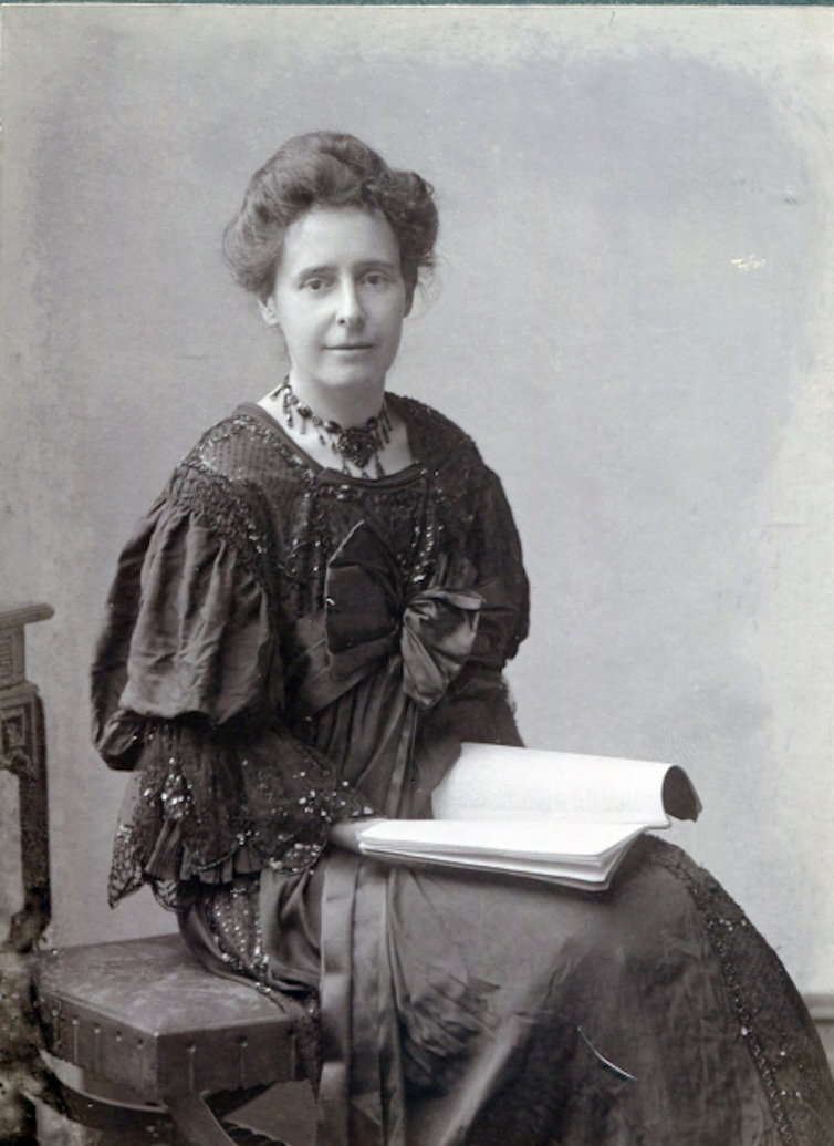 A woman sitting with a book on her lap