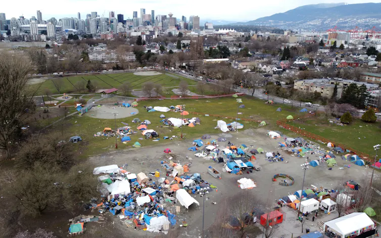 A group of tents and temporary structures in a park, shot from above