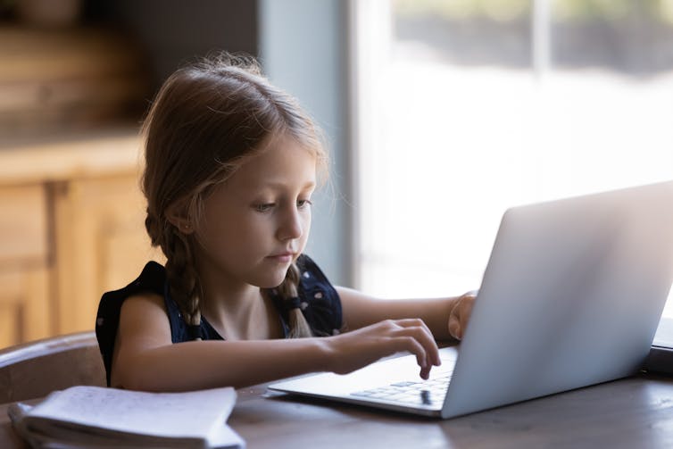 Young girl using laptop computer