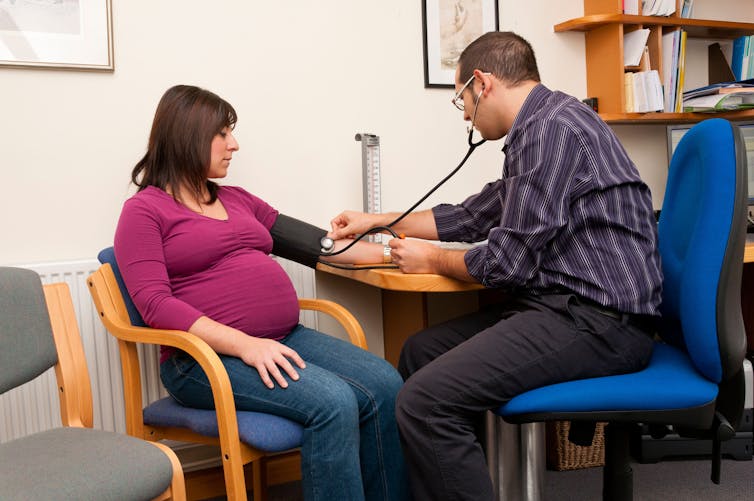 Pregnant woman having her blood pressure checked.