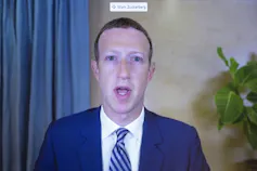 Mark Zuckerberg appears on a screen