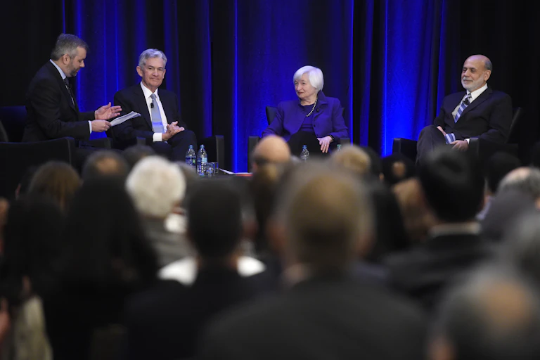 Janet Yellen, Ben Bernanke and Jerome Powell sit on a stage together