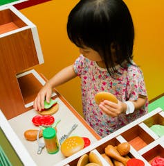 Girl playing groceries.