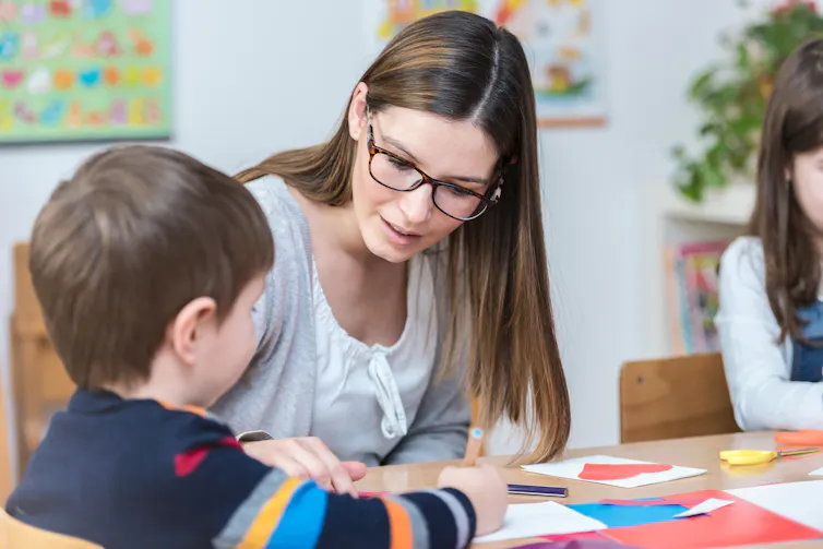 Teacher with children in classroom.