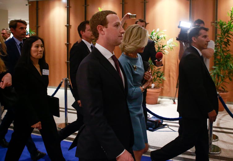Mark Zuckerberg leaving a hearing after appearing before European Parliament