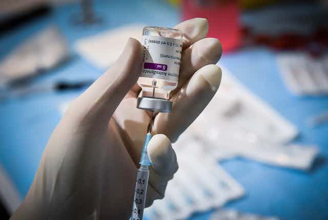 A Italian health worker loading a syringe with AstraZeneca vaccine