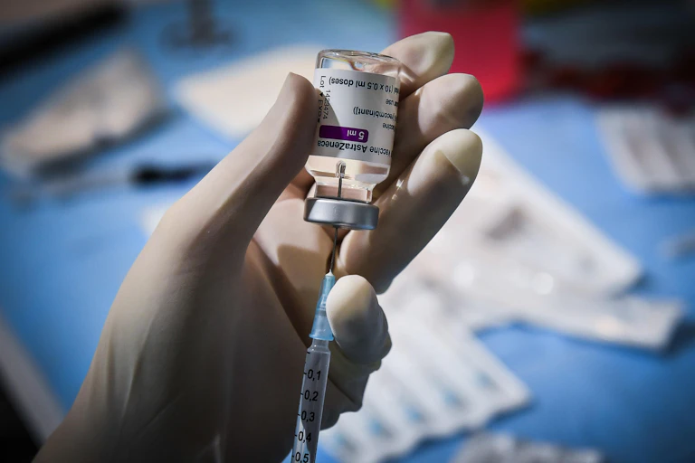 A Italian health worker loading a syringe with AstraZeneca vaccine