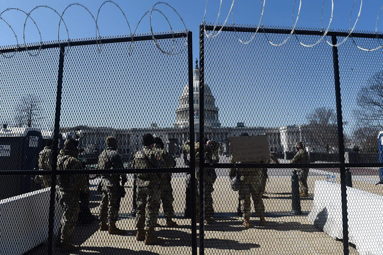 Soldiers and barbed wire block the way to the US Capitol