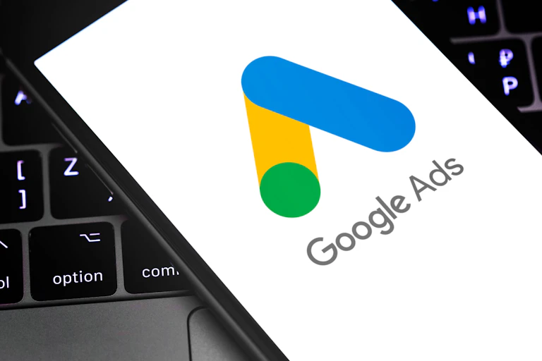 Cellphone with Google Ads lying on a laptop keyboard