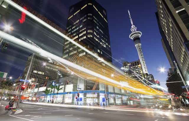 Auckland at dusk with a trail of lights in the  city's streets