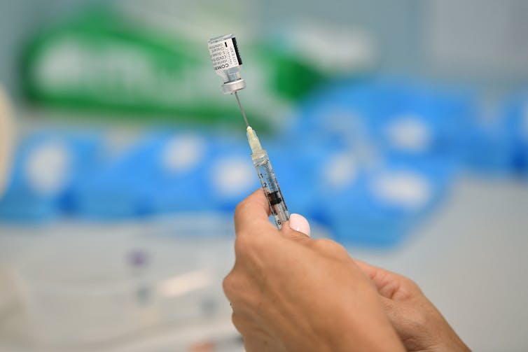 A nurse preparing a dose of the Pfizer vaccine