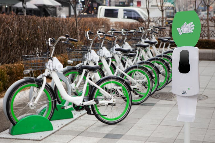 disinfectant stand next to a row of share bikes