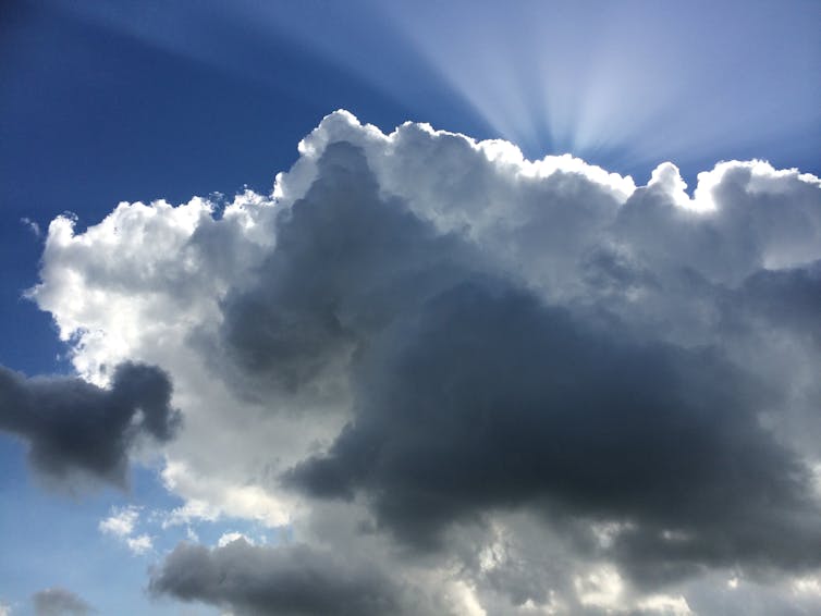 Clouds hiding the Sun but with rays of light emerging from behind top.