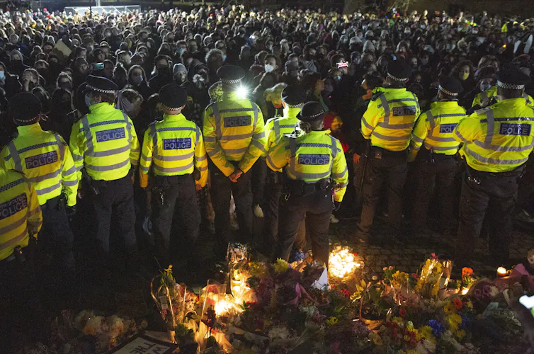 Police line up against protestors in Clapham, London.