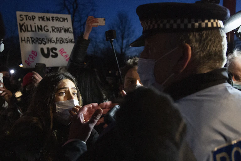 A protester and police officer face each other in Clapham