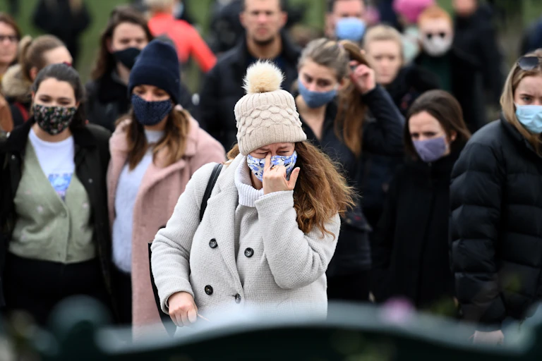 Women gather on Clapham Common, where a memorial for Sarah Everard has been set up.
