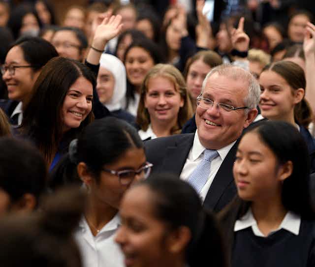 Scott Morrison surrounded by school students