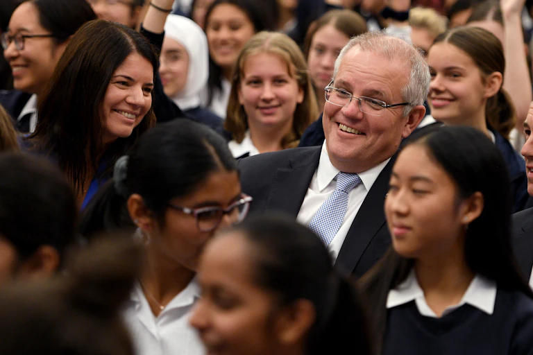 Scott Morrison surrounded by school students