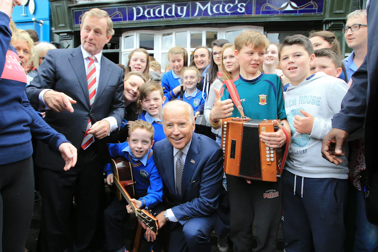 Joe Biden kneels outside Paddy Mac's bar in Ballina, County Mayo durng a vice-presidential visit to Ireland in 2016.