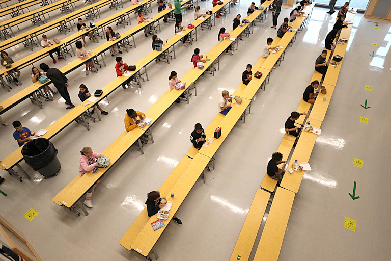 Students social distance in school cafeteria