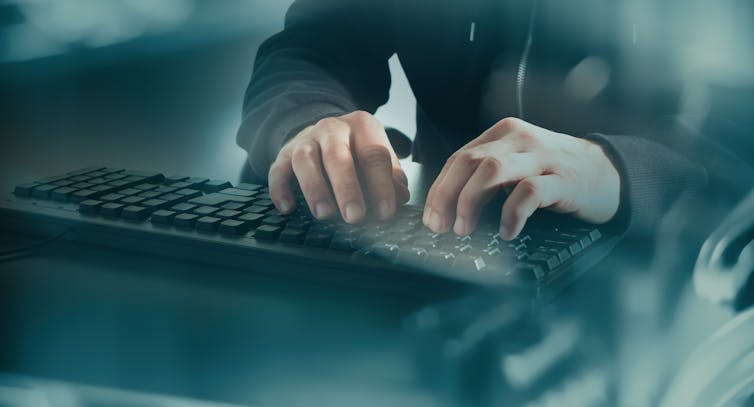 Man typing on computer.