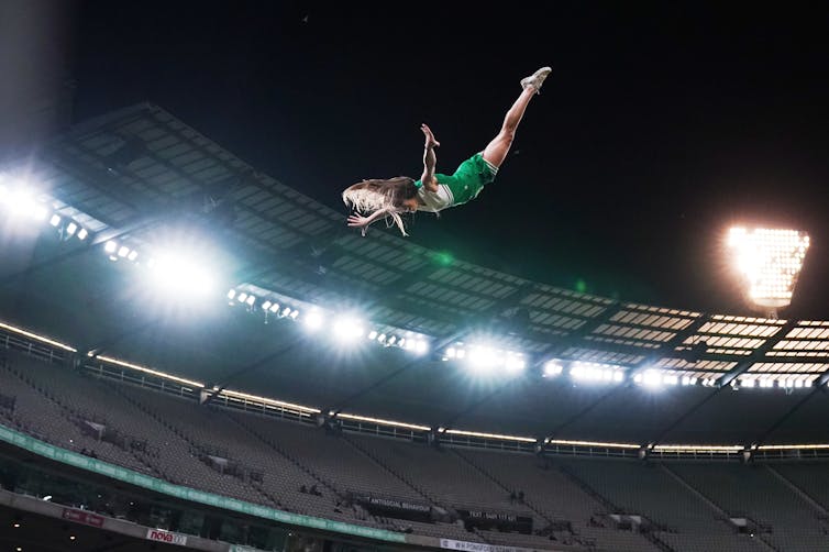 A cheerleader flies through the air