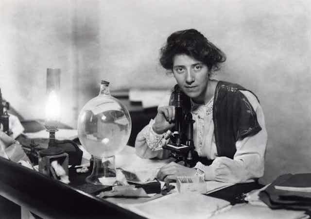 Black and white photo of Marie Stopes in her laboratory.