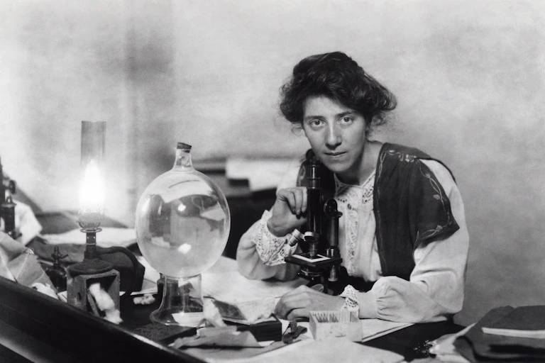 Black and white photo of Marie Stopes in her laboratory.