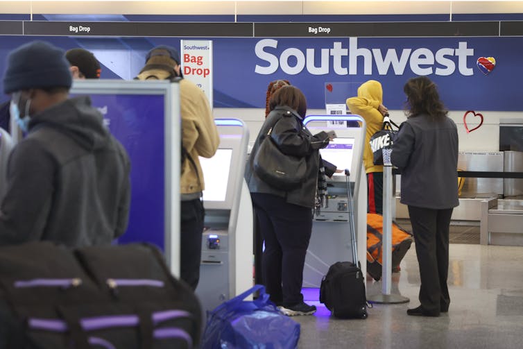 Airline passengers checking in at an airport.